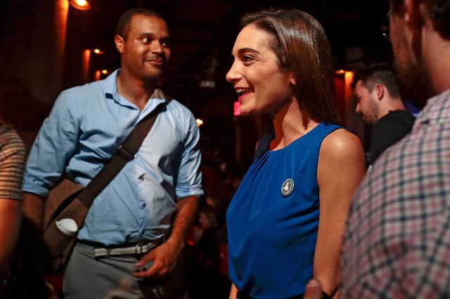 Julia Salazar, right, talks with supporters after winning the Democratic primary over Martin Dilan in New York's 18th State Senate district race.
